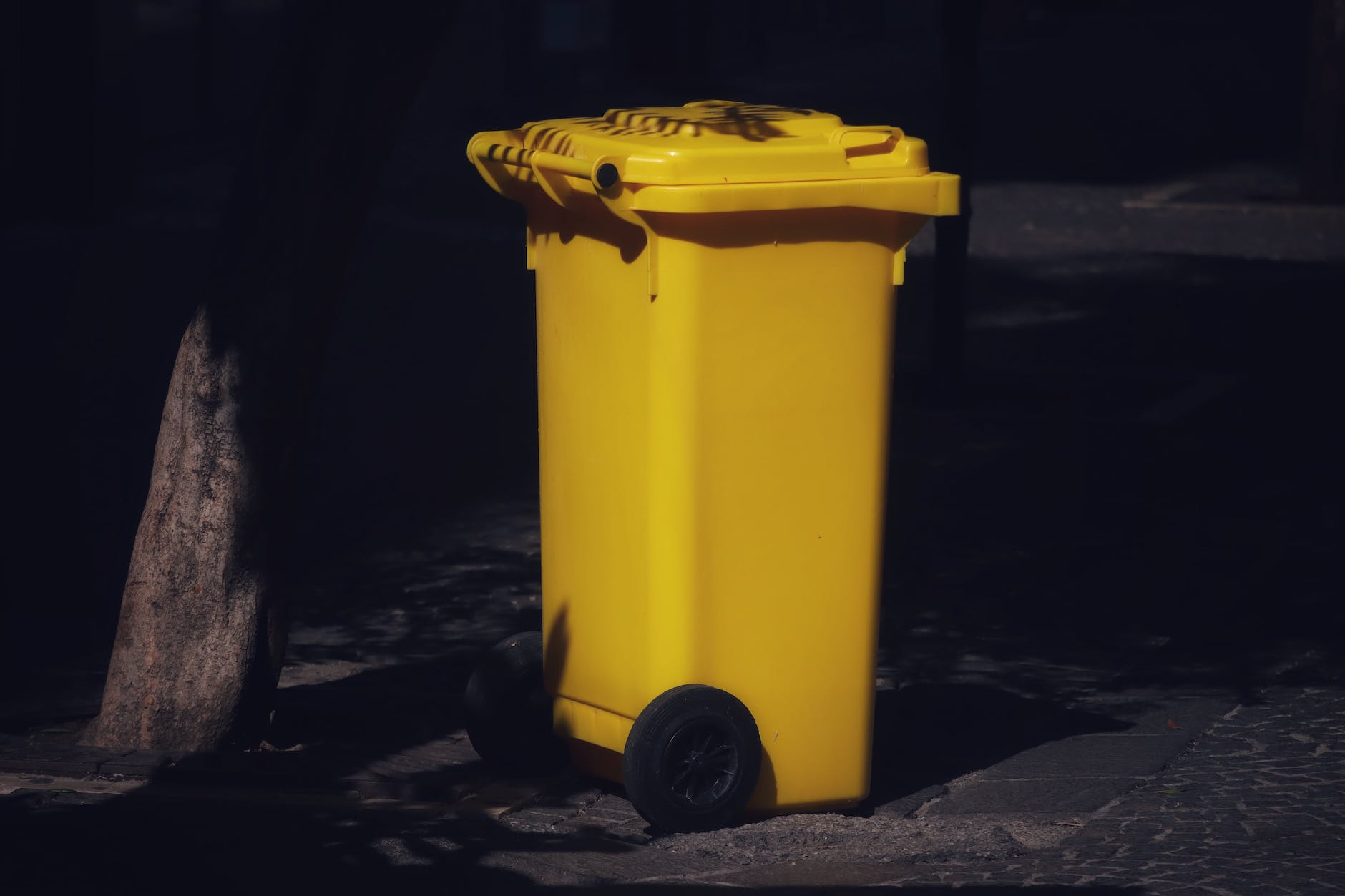 yellow plastic trash bin